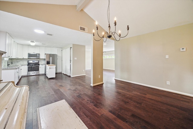 kitchen with a sink, a chandelier, stainless steel appliances, visible vents, and light countertops