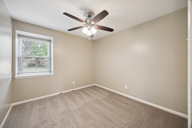 empty room featuring ceiling fan, carpet, and baseboards