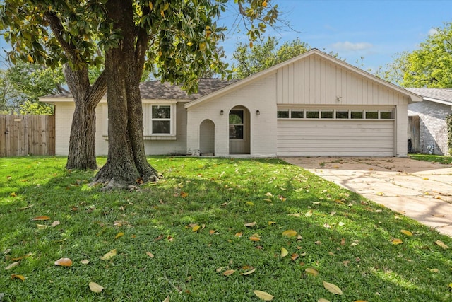 single story home with a garage, brick siding, fence, and concrete driveway