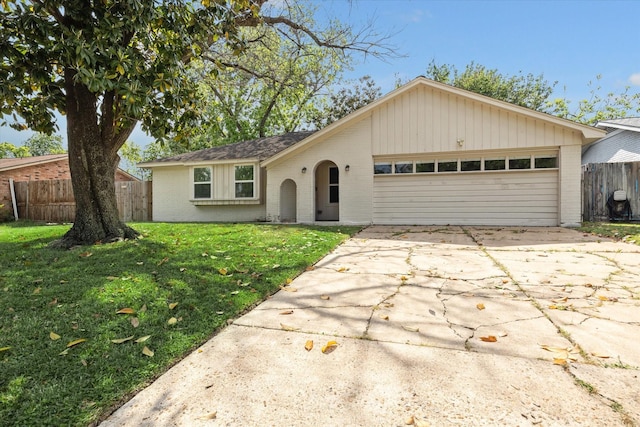 single story home with brick siding, driveway, and fence