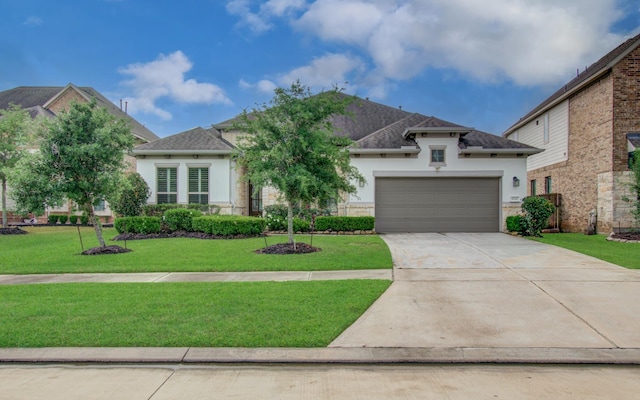 view of front of home featuring a garage, a front lawn, stucco siding, and concrete driveway