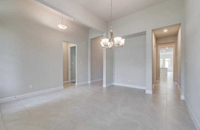 unfurnished room featuring light tile patterned floors, a notable chandelier, and baseboards