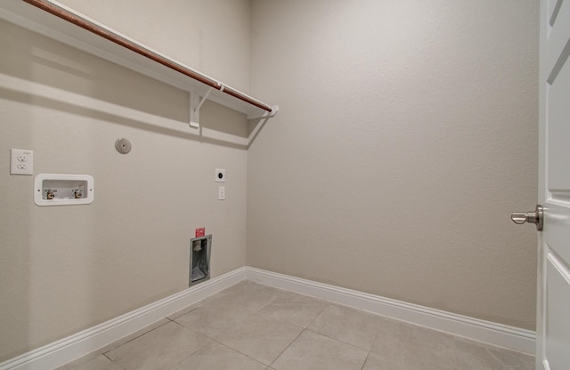 clothes washing area featuring hookup for an electric dryer, hookup for a gas dryer, light tile patterned floors, laundry area, and hookup for a washing machine