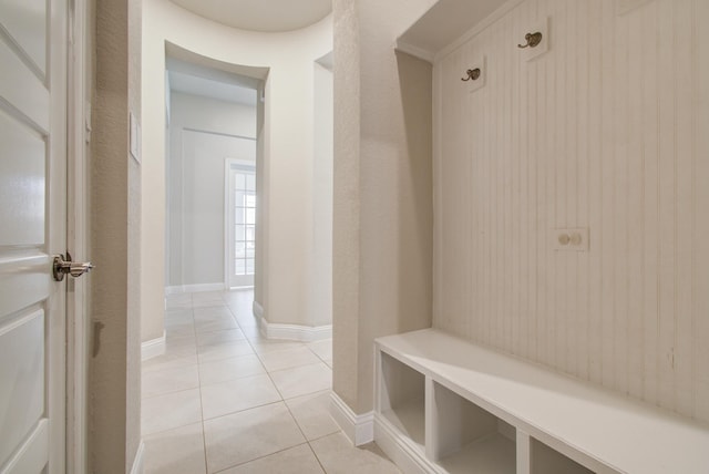 mudroom with light tile patterned flooring and baseboards