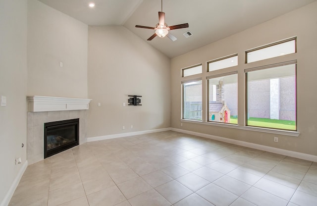 unfurnished living room with a tiled fireplace, light tile patterned flooring, high vaulted ceiling, ceiling fan, and visible vents