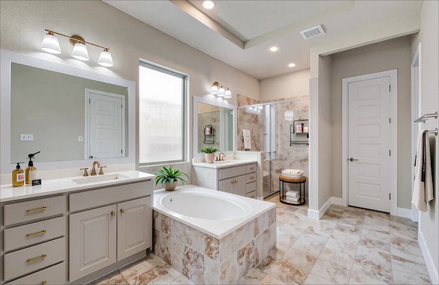 bathroom with a sink, a shower stall, two vanities, visible vents, and a garden tub