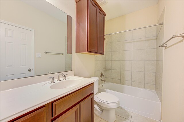 bathroom featuring tile patterned floors, toilet, vanity, and bathing tub / shower combination