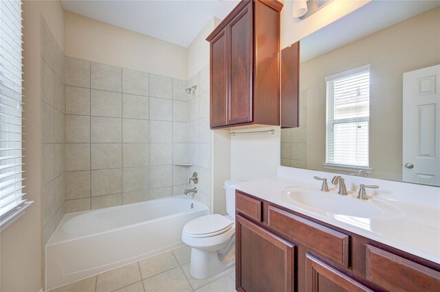 bathroom featuring tile patterned floors, toilet,  shower combination, and vanity
