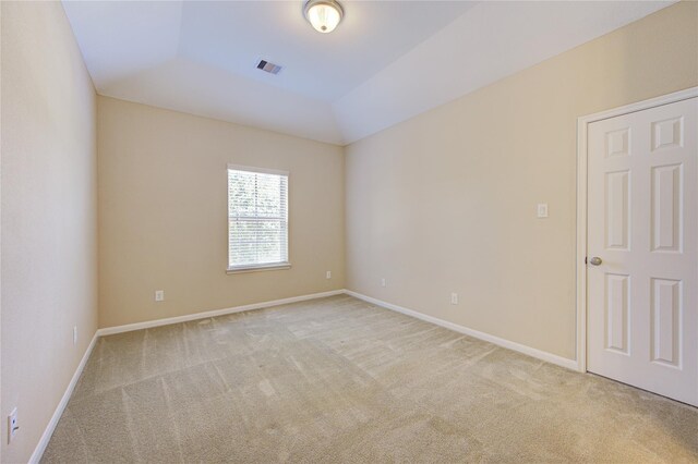 empty room featuring light carpet and baseboards