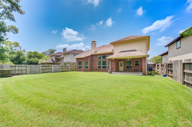 rear view of house with a patio area and brick siding