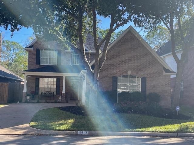 1615 Lakeside Enclave Dr, Houston, TX 77077 - traditional home featuring brick siding and covered porch
