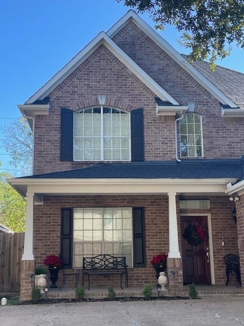 1615 Lakeside Enclave Dr, Houston, TX 77077 - view of front facade with a porch and brick siding