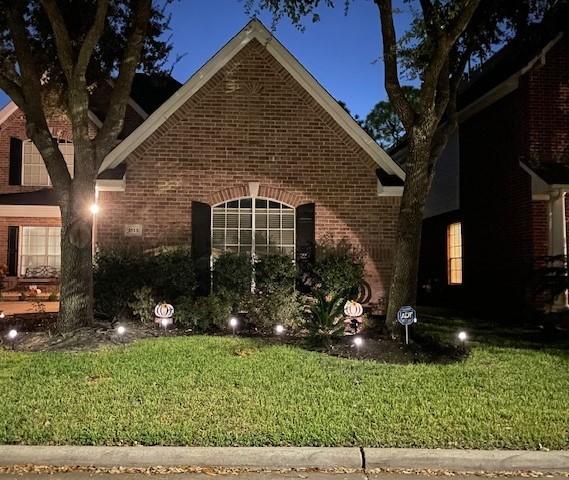 1615 Lakeside Enclave Dr, Houston, TX 77077 - view of side of property featuring brick siding and a yard