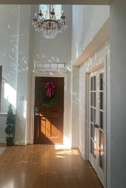 1615 Lakeside Enclave Dr, Houston, TX 77077 - corridor with wood finished floors, a chandelier, and healthy amount of natural light