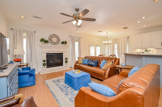 1615 Lakeside Enclave Dr, Houston, TX 77077 - living room with a chandelier, plenty of natural light, ceiling fan, light wood-style floors, and recessed lighting