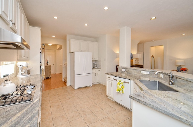 1615 Lakeside Enclave Dr, Houston, TX 77077 - kitchen with a sink, white appliances, recessed lighting, decorative backsplash, and white cabinetry