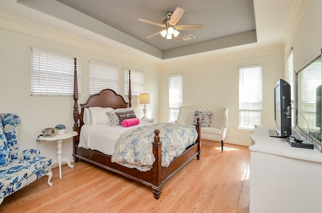 1615 Lakeside Enclave Dr, Houston, TX 77077 - bedroom featuring light wood-style floors, a raised ceiling, and ceiling fan