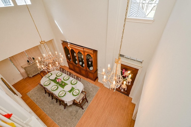 1615 Lakeside Enclave Dr, Houston, TX 77077 - living room with a high ceiling, a chandelier, and wood finished floors