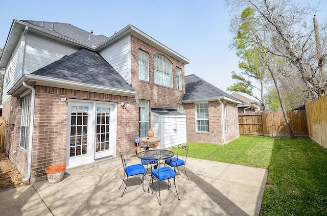 1615 Lakeside Enclave Dr, Houston, TX 77077 - back of house with a patio, brick siding, roof with shingles, and outdoor dining space