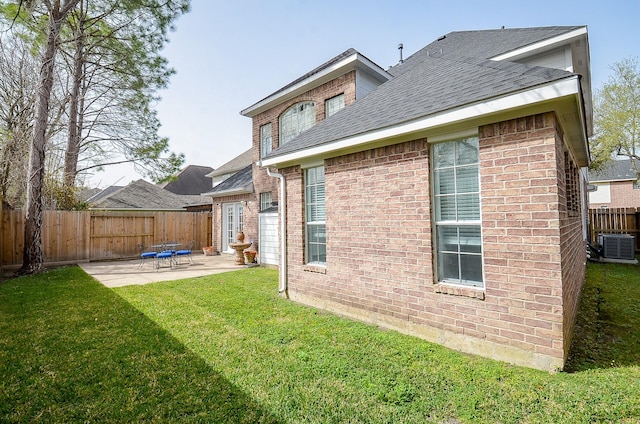 1615 Lakeside Enclave Dr, Houston, TX 77077 - back of house featuring a patio, brick siding, a shingled roof, and central air condition unit