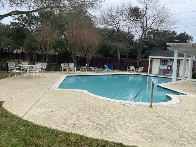1615 Lakeside Enclave Dr, Houston, TX 77077 - community pool featuring a patio area and an outbuilding