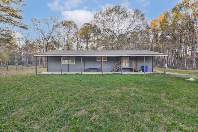 rear view of property with a yard