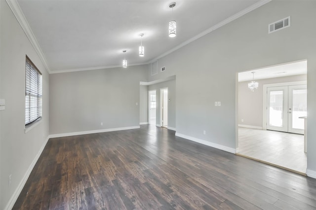 unfurnished living room featuring dark wood-type flooring, visible vents, baseboards, ornamental molding, and french doors