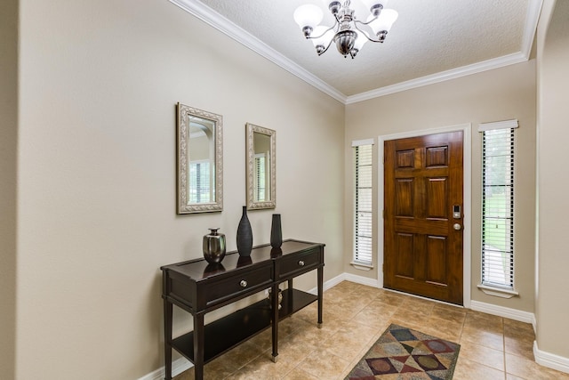 foyer featuring an inviting chandelier, light tile patterned floors, baseboards, a textured ceiling, and crown molding