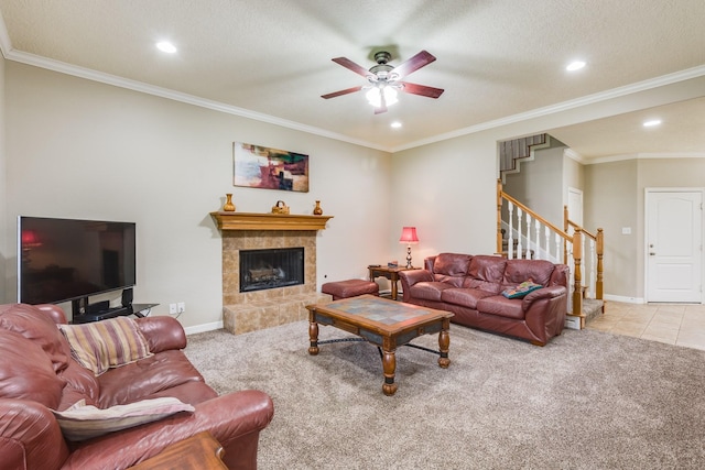 living room featuring baseboards, ceiling fan, stairs, and carpet flooring