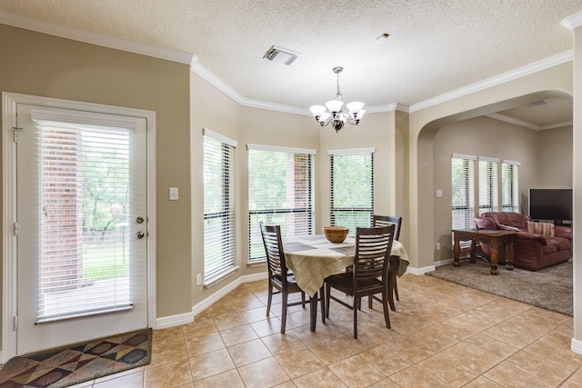 dining area with light tile patterned floors, a notable chandelier, arched walkways, and visible vents
