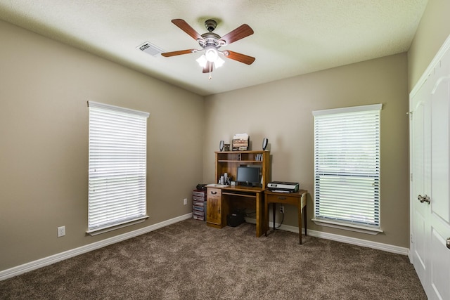 carpeted office with visible vents, a ceiling fan, and baseboards