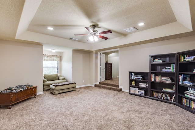 sitting room featuring a textured ceiling, visible vents, a ceiling fan, and carpet floors