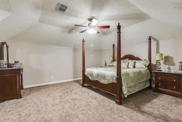 bedroom with lofted ceiling, a textured ceiling, visible vents, and carpet floors