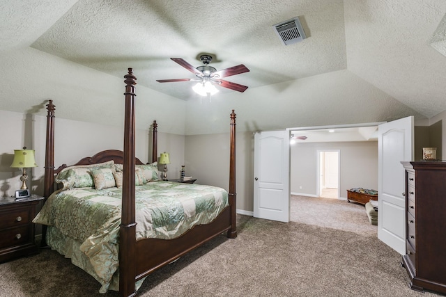 bedroom with dark carpet, a textured ceiling, visible vents, and vaulted ceiling