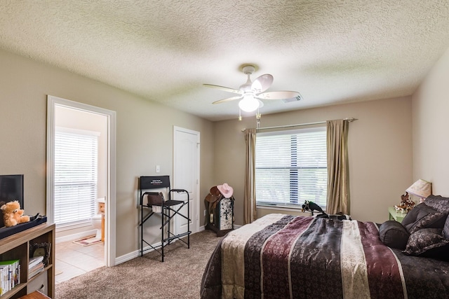 bedroom featuring carpet flooring, ensuite bathroom, multiple windows, and visible vents