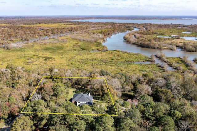 birds eye view of property featuring a wooded view and a water view