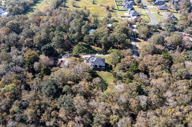 drone / aerial view featuring a wooded view