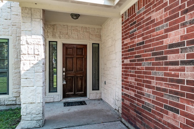 doorway to property featuring stone siding