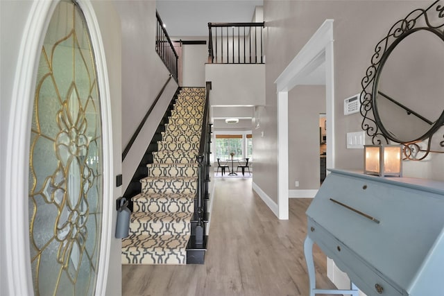 31235 Edgewater Dr, Magnolia, TX 77354 - foyer with stairway, wood finished floors, baseboards, and a towering ceiling