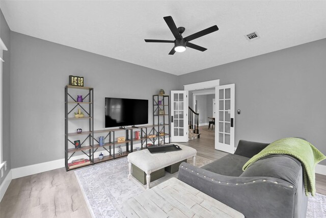 31235 Edgewater Dr, Magnolia, TX 77354 - living area featuring french doors, wood finished floors, a ceiling fan, and baseboards