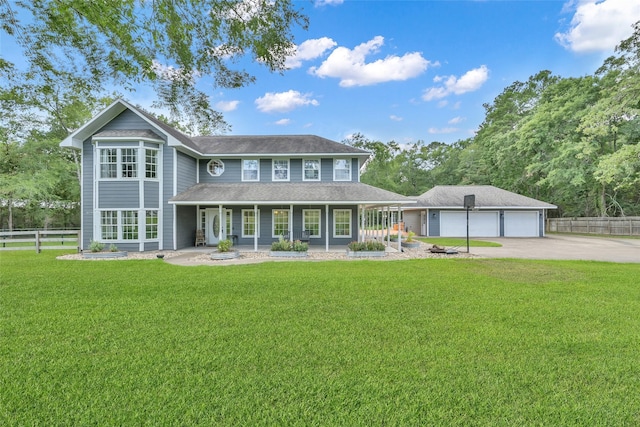 31235 Edgewater Dr, Magnolia, TX 77354 - view of front of property with a porch, a detached garage, an outbuilding, and concrete driveway