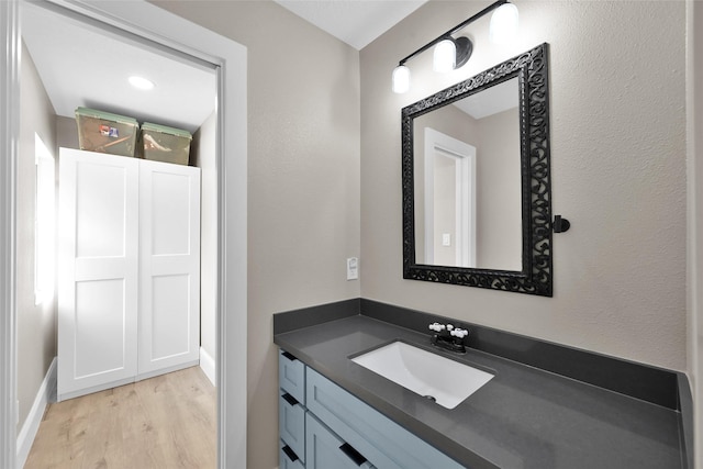 31235 Edgewater Dr, Magnolia, TX 77354 - bathroom featuring wood finished floors, vanity, and baseboards