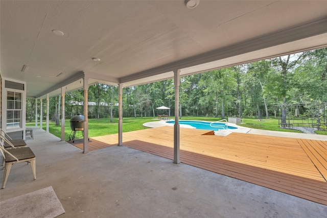 31235 Edgewater Dr, Magnolia, TX 77354 - view of patio / terrace with a wooden deck, a grill, view of wooded area, and an outdoor pool