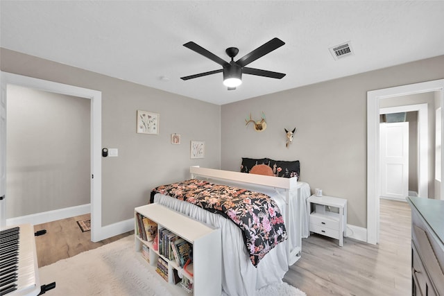 31235 Edgewater Dr, Magnolia, TX 77354 - bedroom featuring light wood-style floors, baseboards, ceiling fan, and heating unit