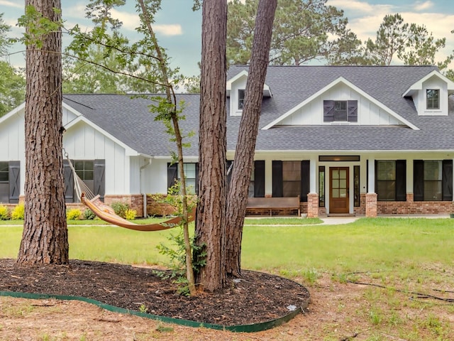 165 Sanctuary Rd, Huntsville, TX 77340 - view of front of home featuring brick siding, board and batten siding, and roof with shingles