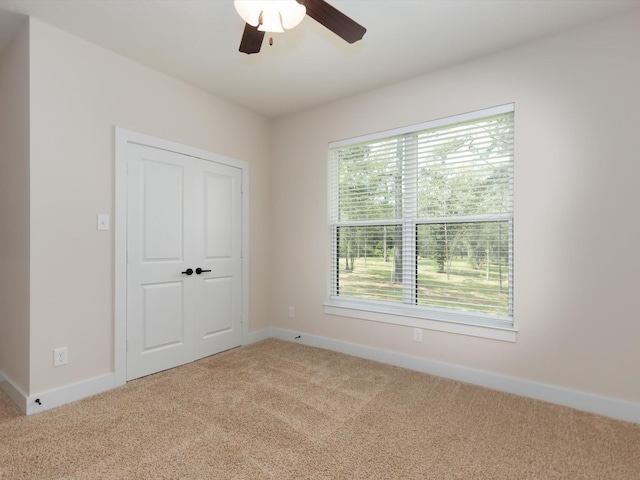 165 Sanctuary Rd, Huntsville, TX 77340 - unfurnished bedroom with baseboards, a ceiling fan, and carpet