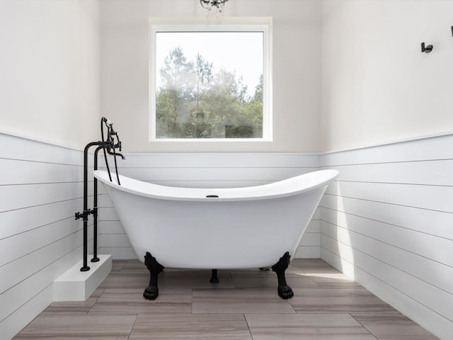 165 Sanctuary Rd, Huntsville, TX 77340 - bathroom featuring a freestanding bath and a wainscoted wall