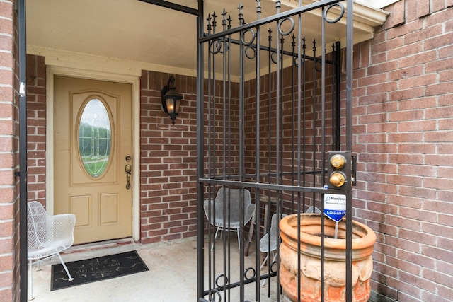 property entrance featuring brick siding