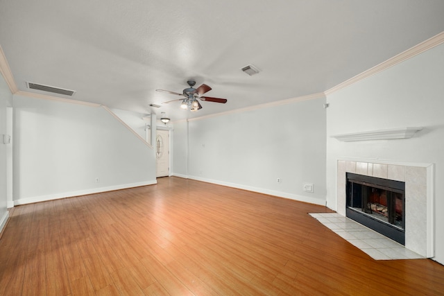unfurnished living room featuring visible vents, a ceiling fan, light wood-style flooring, and crown molding