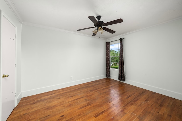 unfurnished room featuring ornamental molding, wood finished floors, and baseboards